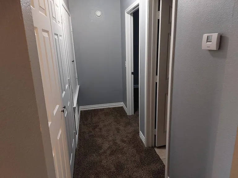 Hallway to laundry room, 2nd bathroom and 2nd bedroom