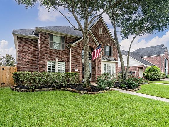 Mature trees, lush landscaping w/rock border and pretty foliage offers such great curb appeal!