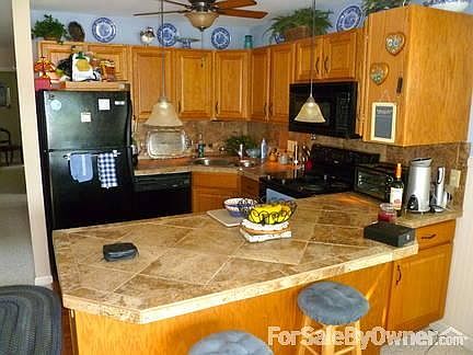 Kitchen, taken from fireplace. : New tile counter top and back splash.