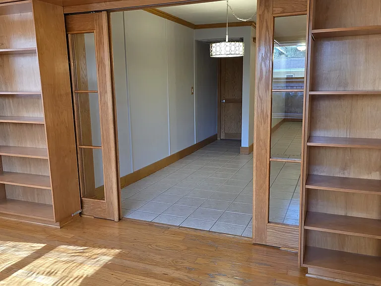 Coming from the Florida room back into the Family room looking into dining area and door to the garage