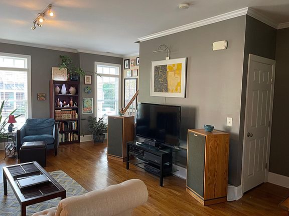 View of living room, stairs and storage space under the stairs.