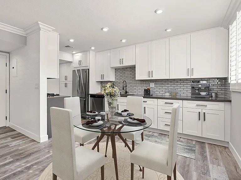 Hardwood floored dining room with view of gorgeous tiled kitchen.