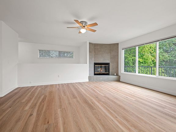 Living room with wood burning fireplace.