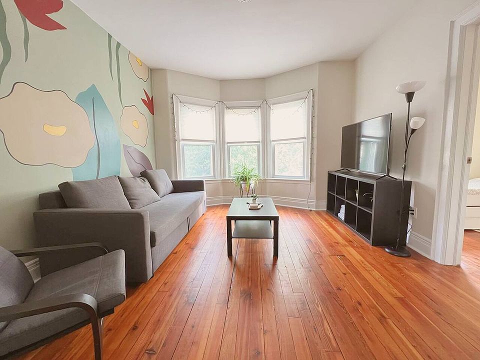 Enjoy our living room with a pull-out sofa, a 55-inch UHD Roku TV & custom mural hand-painted.