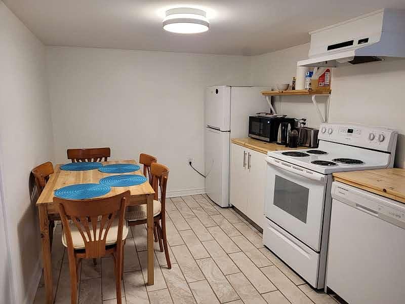 Full kitchen with dishwasher, toaster, and microwave