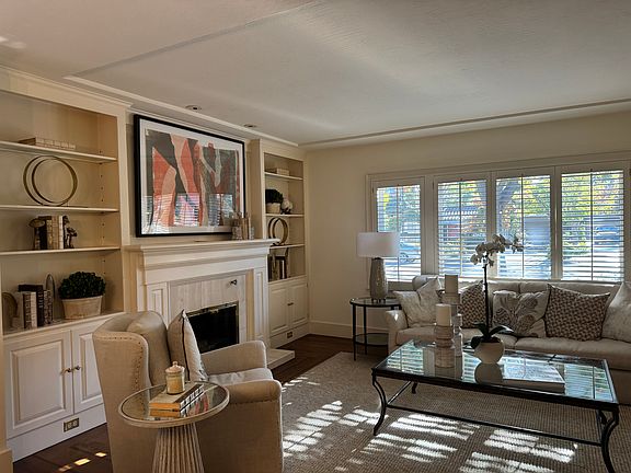 The living room with a fireplace and built in custom cabinet
