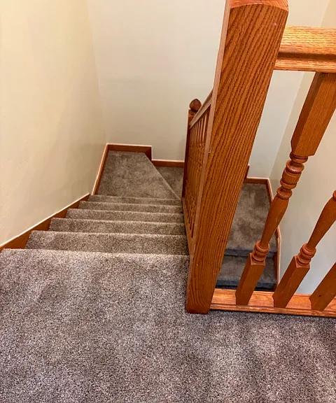 Top of the stairway ` nice wood, new carpet.