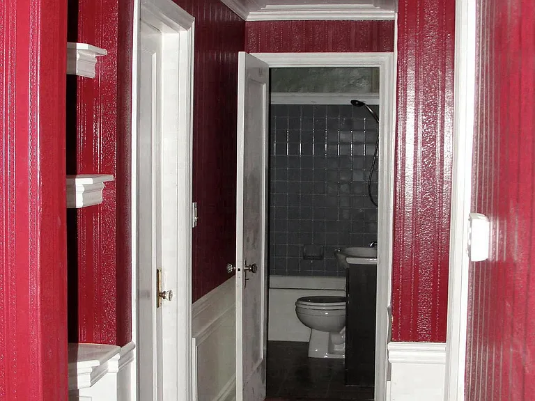 from front door bedroom door on left, bathroom in rear and k