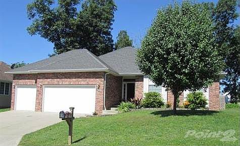 Front view of home with a brick and permanent sided exterior.