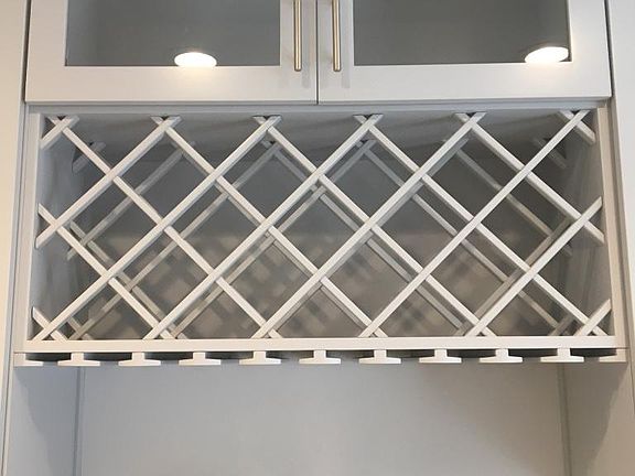 Beautiful updated glass cabinetry with a new wine rack
