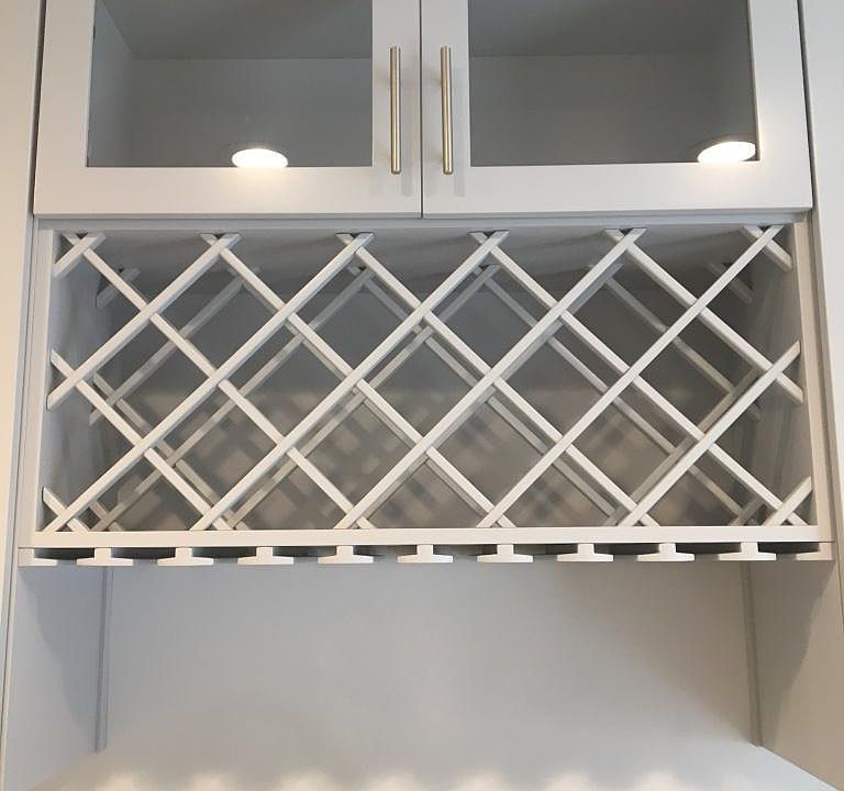 Beautiful updated glass cabinetry with a new wine rack