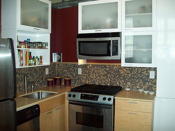 Dream kitchen has beautifully tiled backsplash, quartz stone counter tops, European style cabinets, 