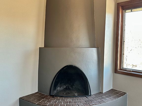 Dining room wood burning kiva fireplace.