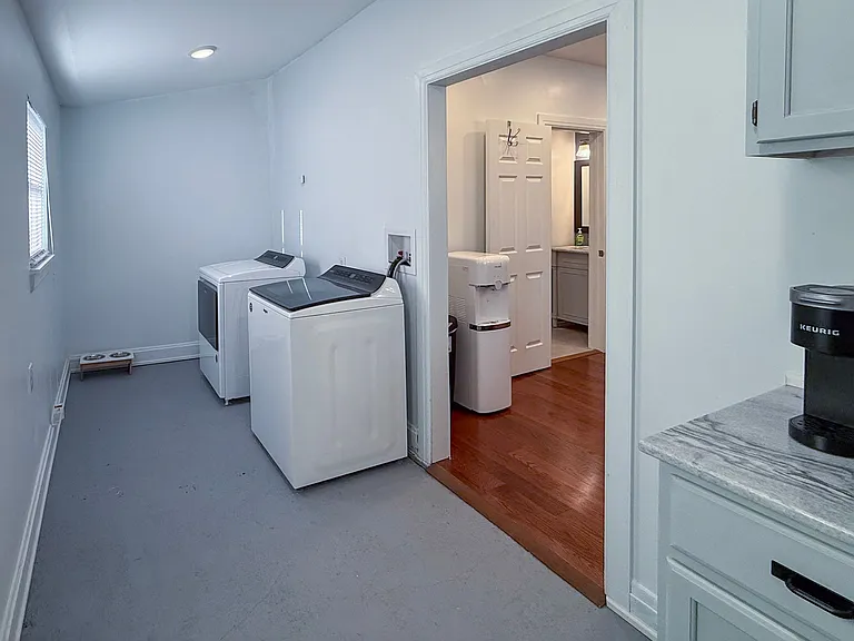 Large mudroom with washer/dryer, coffee/microwave area, and space pet feeding area