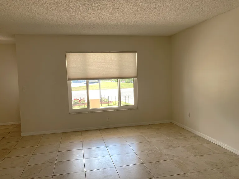Living room with remote controlled window blind