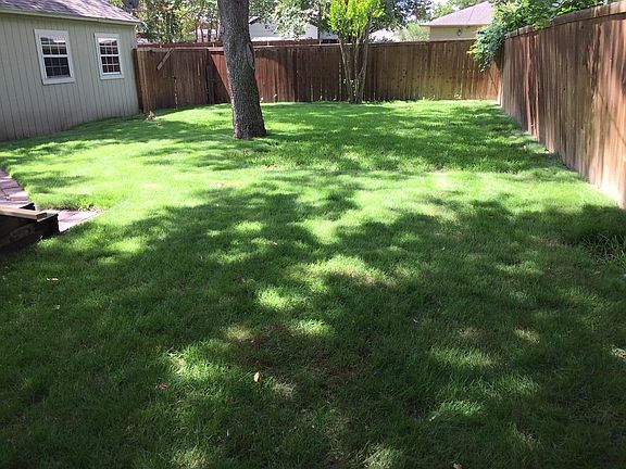 Extra large sprinkler back yard with large Pecan Tree