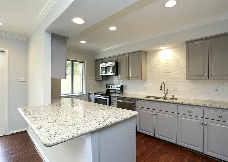 This Stunning renovated home is fresh and inviting with its tone on tone kitchen featuring subway ti