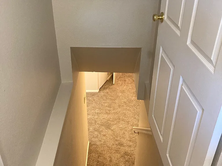 Carpeted finished basement has two more bedrooms, another living area, full bathroom, and a very large storage room.