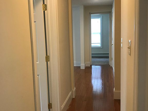 Hallway -first bedroom on left. Across hall on right are 2 full bathrooms (both with showers) and a stack washer/dryer in-between the bathrooms. Next on left is living area, straight ahead is 2nd bedroom /or work from home space.