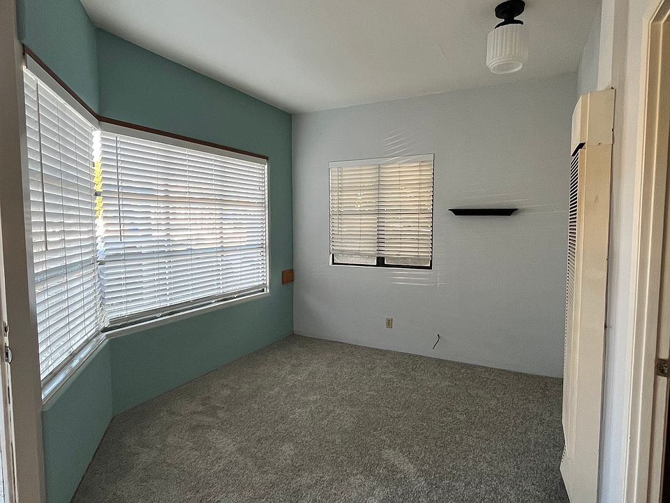 Living room with fresh paint and new carpet.