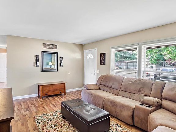 View toward entry door, center hall to beds & baths on the left of frame.  Flooring shown here continues through the breakfast r
