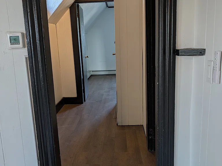This is the main entrance hallway which includes an additional closet (not viewed in picture). The photo was taken from the living room and is looking into the master bedroom.