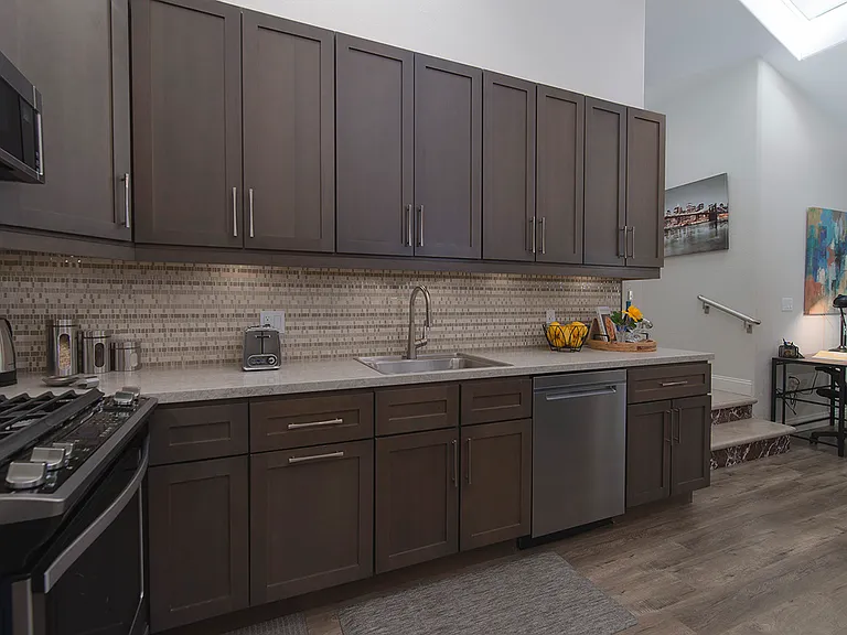 Tall kitchen cabinets and storage space. Full length under cabinet lighting.