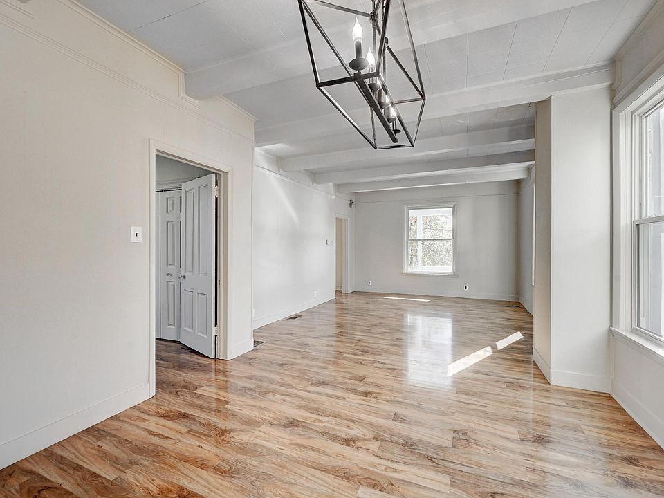 Large living room has lots of windows for great southern light and there is a main floor bedroom with large closet, too!