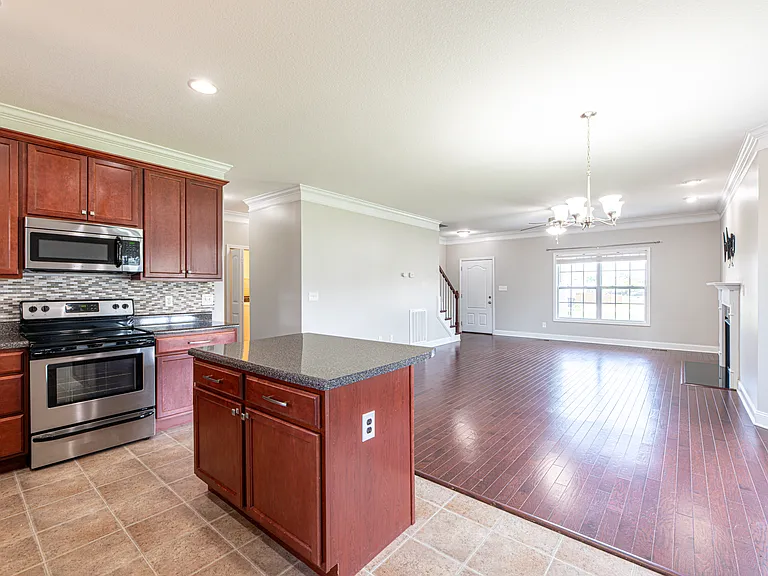 All stainless steel appliances, with touch free sink faucet and stone backsplash
