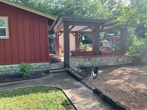 There is a grassy side yard and a pea gravel covered back yard, next to the patio area.