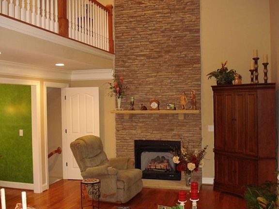 Beautiful great room with floor to ceiling rock FP surround