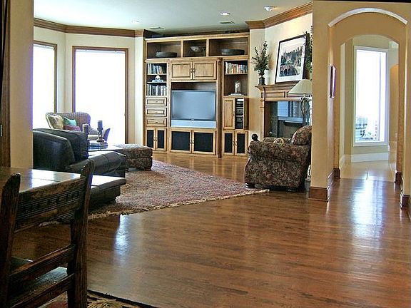 Family Room has built-ins, wood floors, fireplace and great golf course view 
