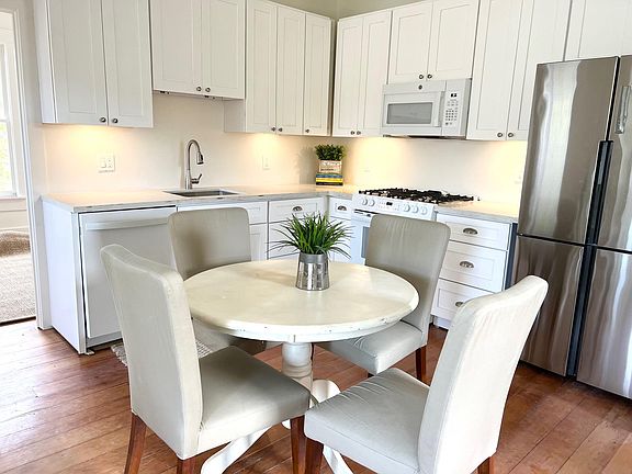 Newly renovated kitchen with dishwasher, gas range, microwave and washer/dryer