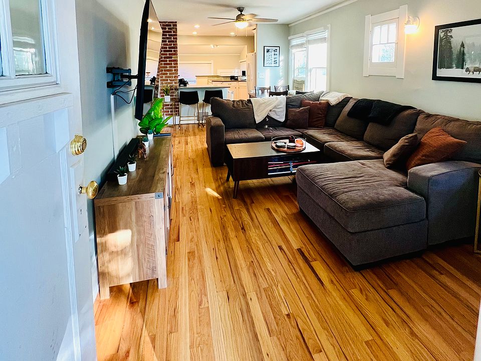 As you step inside from the front patio, you're welcomed by a warm and inviting living room featuring hardwood floors that add both elegance and charm.
