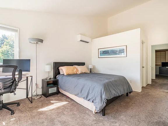 Master bedroom with climate control unit, artwork, and desk