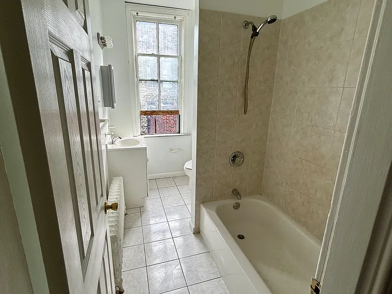 Tiled bathroom with all updated fixtures.