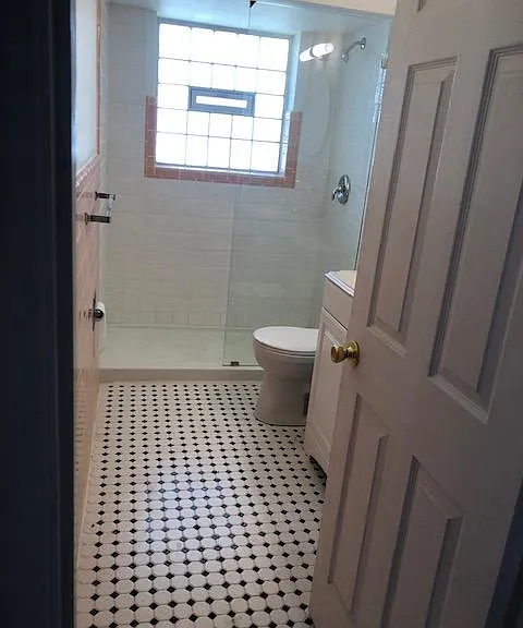 Renovated bath with linen closet.