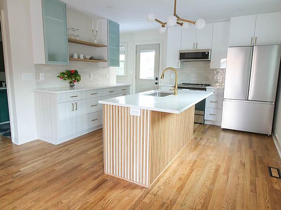 Lots of kitchen storage with modern brass accents.
