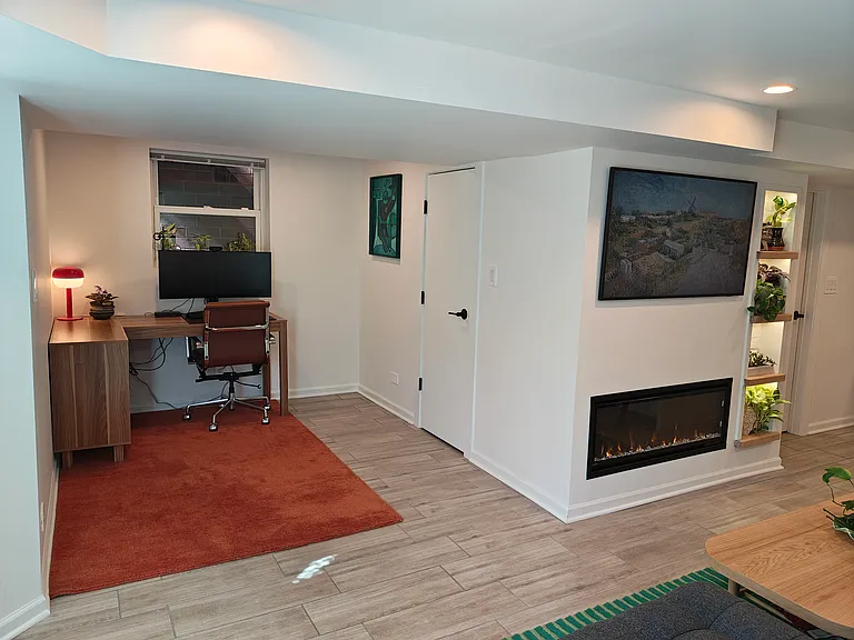 More of a sense of the layout. The office/den area and the living room, with the electric fireplace.