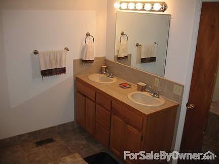 Master Bedroom
						:
						Entrance to master bathroom with jetted tub in background.
