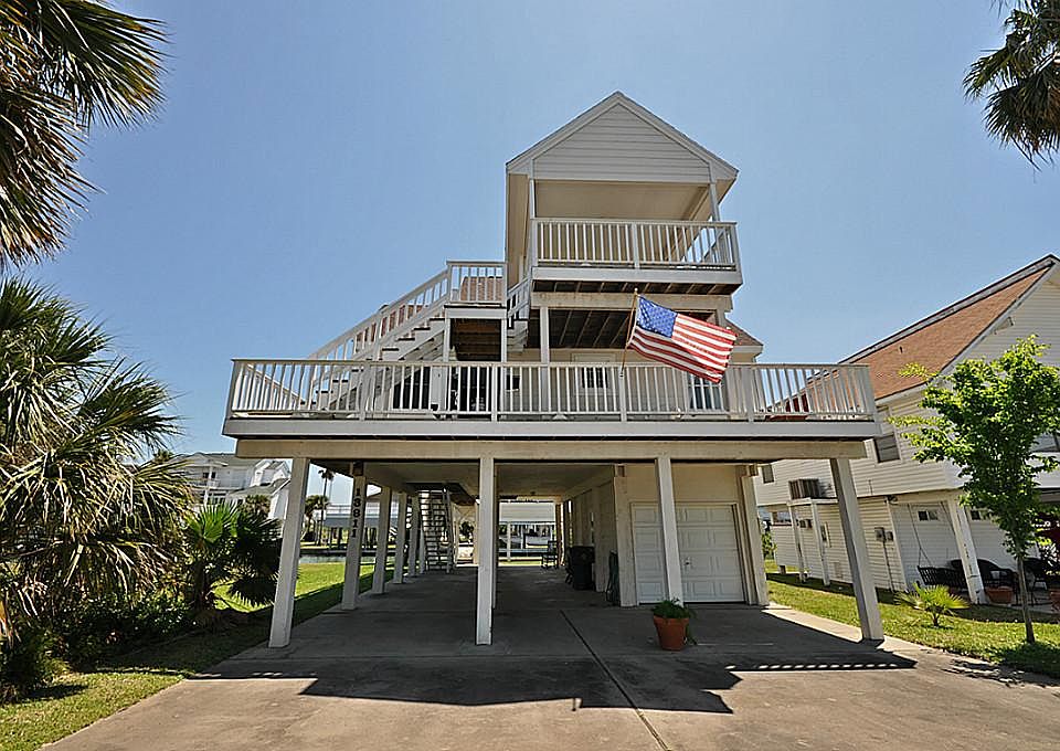 Street side of this 3/2 canal home with bay views to the North and Southerly breezes from the South 