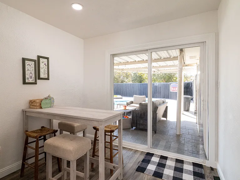 Dining area off the kitchen, featuring a cozy table with seating for four and a convenient pass-through to the kitchen or outside_ideal for casual meals and easy serving.
