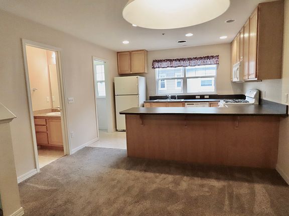 Looking toward the kitchen, 1/2 bath, and pantry from the Dining area.