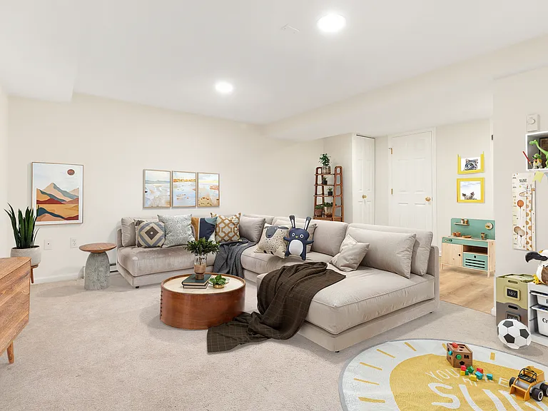 Lower Level, Family Room (with full laundry area and full bathroom) - this image is staged.