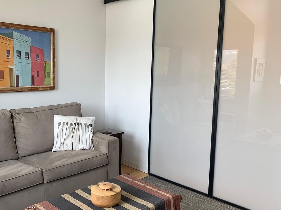 Large barn doors close off living room from kitchen & dining room.