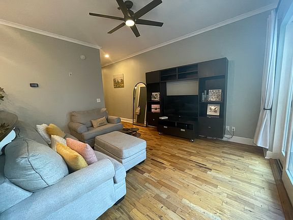 Living room with media station. Media station is mounted on the wall and cannot be moved.