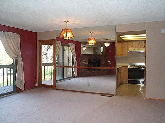 Living room with wall of mirrors, glass slider to deck