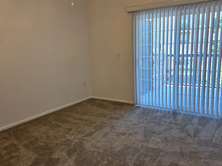 Guest Bedroom facing sliding glass door to balcony.