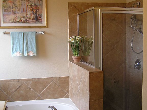 Large master bath w/separate shower and tub his/her sinks and oak cabinets