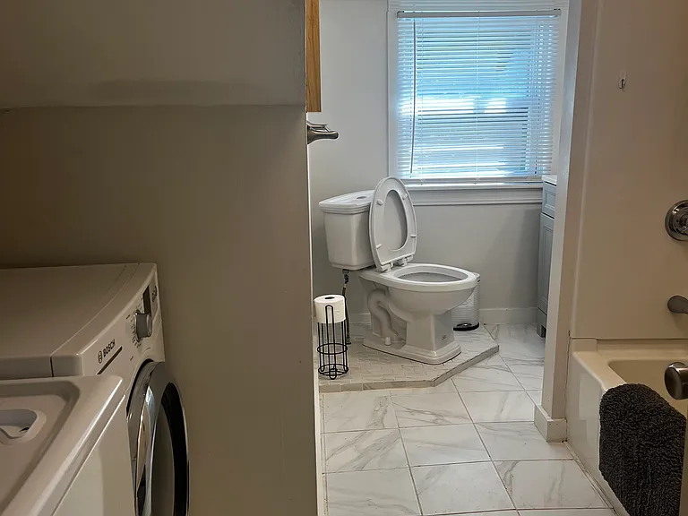 Porcelain Tile & newer dove gray cabinetry, dimmable LED lights, Maytag washer & Bosch dryer_ standard size TUB & shower